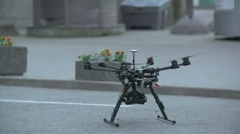 Six Rotor Drone with Camera on Gimbal flying in the Sky. Shot in Slow motion. Video stock 64990834