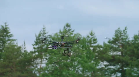 Six Rotor Drone with Camera on Gimbal flying in the Sky. Shot in Slow motion. Stock Footage 64990871