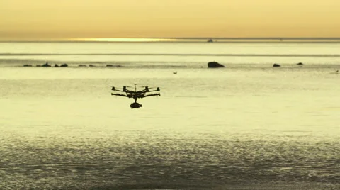 Six Rotor Drone with Camera on Gimbal flying in the Sky. Shot in Slow motion. Stock Footage 64990979