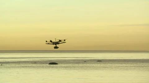 Six Rotor Drone with Camera on Gimbal flying in the Sky. Shot in Slow motion. Stock Footage 64990994