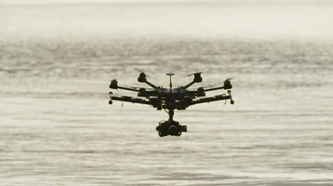 Six Rotor Drone with Camera on Gimbal flying in the Sky. Shot in Slow motion. Stock Footage 64991001