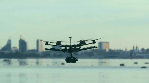 Six Rotor Drone with Camera on Gimbal flying in the Sky. Shot in Slow motion. Vídeo Stock 64991033
