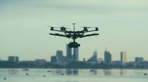 Six Rotor Drone with Camera on Gimbal flying in the Sky. Shot in Slow motion.  Vídeo Stock 64991040