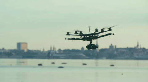 Six Rotor Drone with Camera on Gimbal flying in the Sky. Shot in Slow motion.  Stock Footage 64991043
