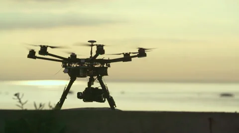 Six Rotor Drone with Camera on Gimbal flying in the Sky. Shot in Slow motion. Stock Footage 64991084