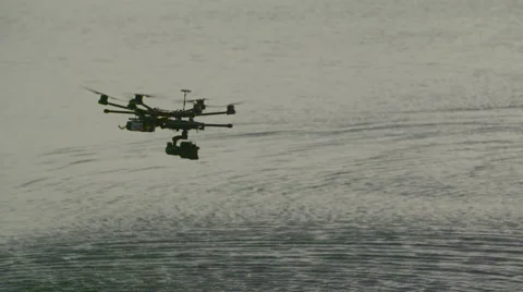 Six Rotor Drone with Camera on Gimbal flying in the Sky. Shot in Slow motion. Stock Footage 64991301