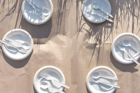 Six sets of disposable biodegradable spoons, forks, plates of corn starch Stock Photos