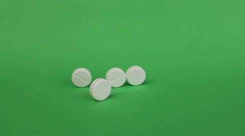 Six tablets rolling out one after the other in the frame, green background 動画素材 25877462