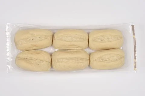 Six white bread rolls in clear plastic wrap Stock Photos