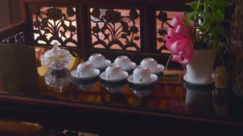 Six white ceramic tea cups are placed upside down on their respective plates Stock-Footage 333365302