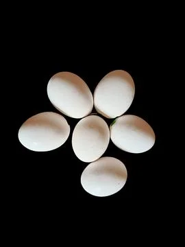 Six white eggs on black background Foto stock