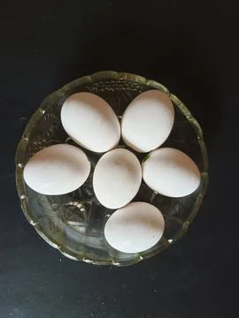 Six white eggs on black background Foto stock