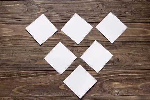 Six white post-in notes on wooden background Stock Photos