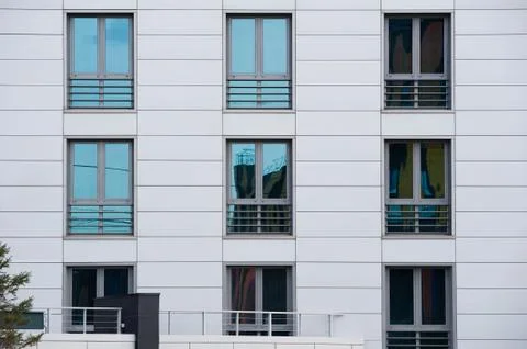 Six-window wall of a modern gray building Stock Photos