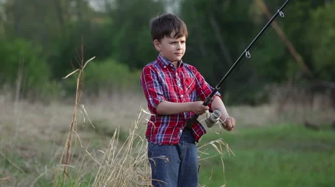 Six year old boy catches a fish. his mom kisses him Stock Footage 63198822