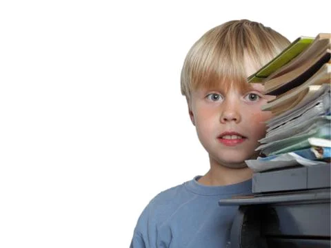 Six year old boy surrounded by piles of books isolated Stock Photos