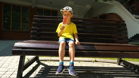 A six year old child eats ice cream. Stock Footage 109565010