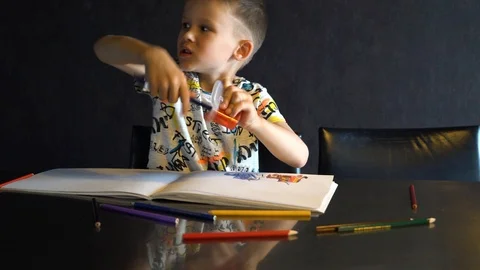 A six-year-old child sharpens colored pencils. Stock Footage 109560805