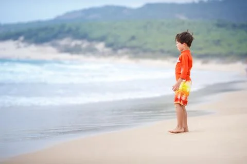 Six years old boy playing on exotic beach Stock Photos