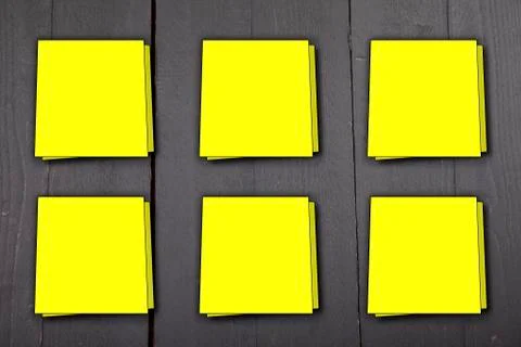 Six yellow memo notes on dark black wooden background Illustrazione stock