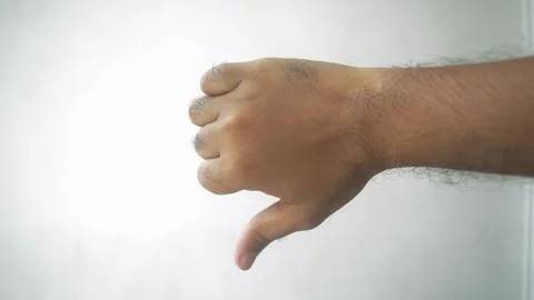 Sixteen frames show a hand with a thumbs down gesture, symbolizing disappro.. Stock Footage 332913005