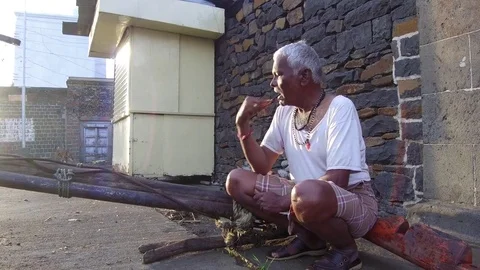 Sixty year Indian man brushing his teeth Stock Footage 77648832
