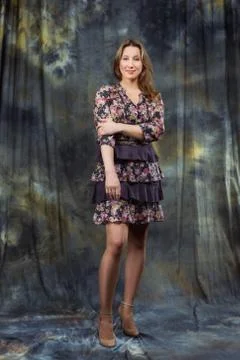 Size plus model in dress posing in studio over abstract background Stock-Fotos