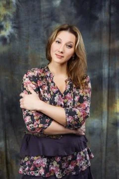 Size plus model in dress posing in studio over abstract background Stock-Fotos