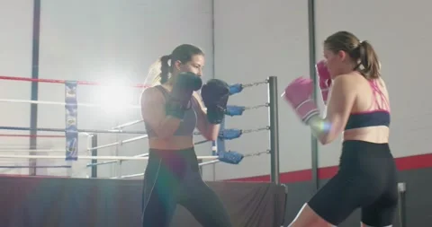 Sizing each other up, female sparring partners training in ring trading jabs and Stock Footage 338060237