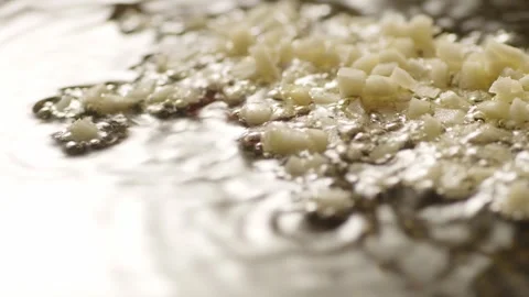 Sizzle garlic in oil in a pan. Stock Footage 263758558