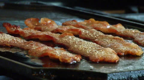 Sizzling Bacon Cooking in Grease Stock Footage 24702881