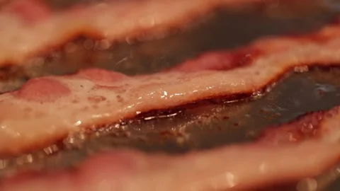 Sizzling bacon in slow motion Stock Footage 149118651