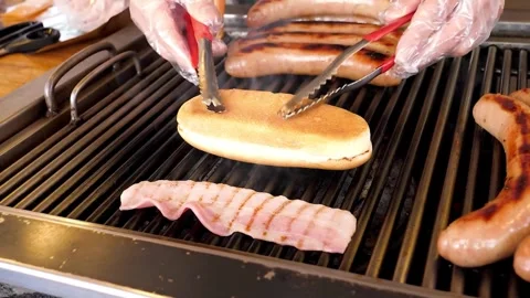 Sizzling Bacon Strips Grilling on a Hot Barbecue Grate Stock Footage 331954927