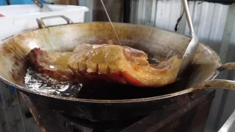 Sizzling Crispy Pork Belly Deep Frying in Large Metal Pan Stock Footage 338211148