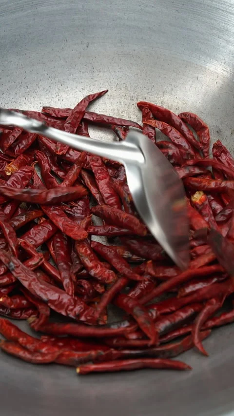Sizzling dried red chili pepper roasting inside hot metal wok, exciting spi.. Stock Footage 341273286