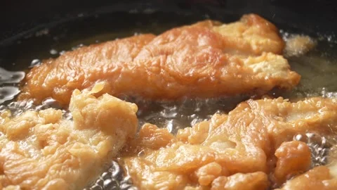 Sizzling Fish Fillets in Frying Pan with bubbling oil. Stock Footage 258571877