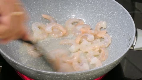 Sizzling Fresh Raw Prawns Stir-Frying in a Hot Non-Stick Wok Pan, Close Up Video stock 329106492