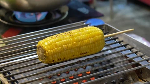 Sizzling Grilled Corn on the Cob at a Thai Street Food Stall | Close-Up 4K Video stock 348392525