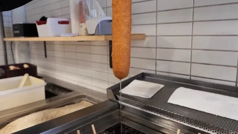 Sizzling Korean Corn Dogs Deep Frying in Hot Oil Stock Footage 331955729