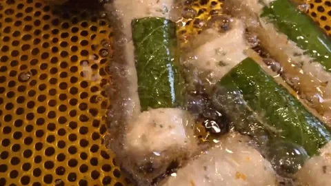 Sizzling Korean Fish Cake Rolls (Eomuk) Wrapped in Perilla Leaves on Griddle Stock Footage 337374935
