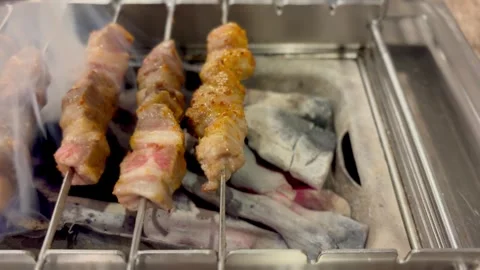 Sizzling Lamb Skewers Roasting On Automatic Charcoal Grill 4K Cinematic Video Stock Footage 327048486