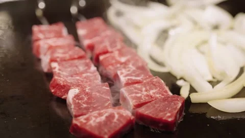 Sizzling Marbled Wagyu Beef Cubes and Onions on Hot Grill Stock Footage 337440969