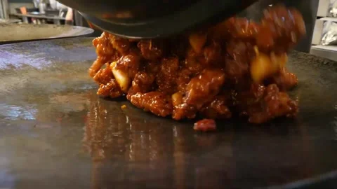 Sizzling Orange Chicken Being Tossed and Poured into a Hot Wok Video stock 343027161