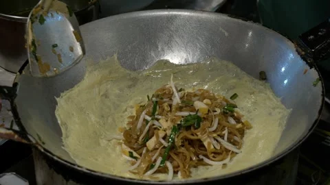 Sizzling Pad Thai Wrapped in Egg at a Thai Night Market | Authentic Street Food Video stock 348392404