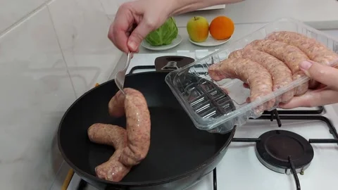 Sizzling Sausage Magic: Pan-Cooked Perfection Stock Footage 304867782