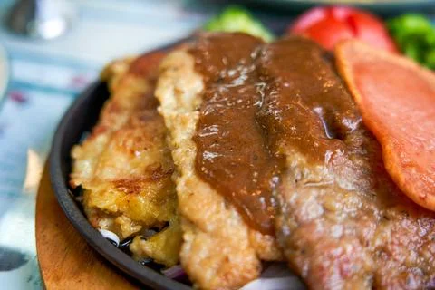 Sizzling steak, chicken, and pork chop in a Hong Kong-style tea restaurant Stock Photos