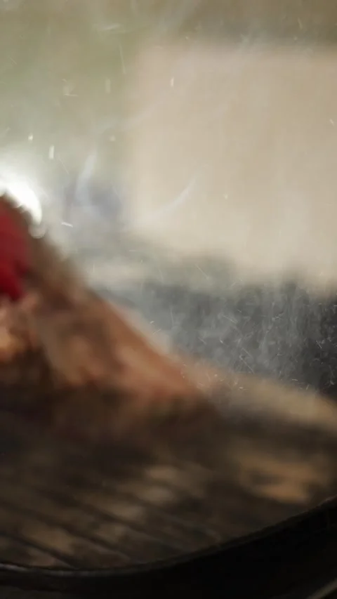 Sizzling steak cooking on a grill pan with tongs turning the meat Stock Footage 340563286