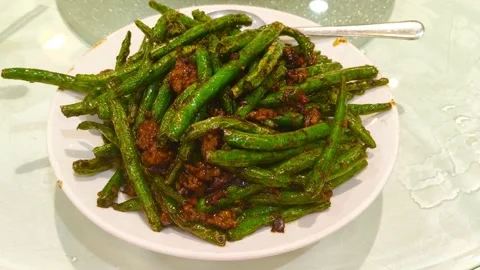 Sizzling stir-fried green beans with savory ground pork, a vibrant dish 動画素材 318311142