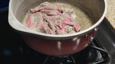 Sizzling Strips of Beef Seared in Hot Oil Stock Footage 318275447