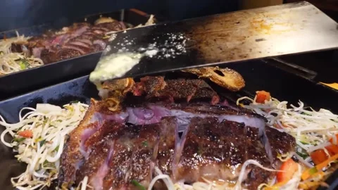 Sizzling T-Bone Steak Cooking on Hot Plate Stock Footage 332817441